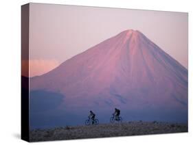 Mountain Biking in Atacama Desert Against a Backdrop of Perfect Cone of Volcan Licancabur 5916 M-John Warburton-lee-Stretched Canvas