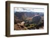 Mountain Goat Stands at the Edge of Bouldery Cliff at the Maroon Bells in Colorado-Kent Harvey-Framed Premium Photographic Print