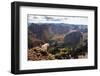 Mountain Goat Stands at the Edge of Bouldery Cliff at the Maroon Bells in Colorado-Kent Harvey-Framed Premium Photographic Print