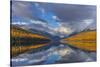 Mountain peaks reflect into Bowman Lake in autumn, Glacier National Park, Montana, USA-Chuck Haney-Stretched Canvas