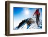 Mountaineer Walking up along a Snowy Ridge with the Skis in the Backpack. in Background a Shiny Bri-Roberto Caucino-Framed Photographic Print