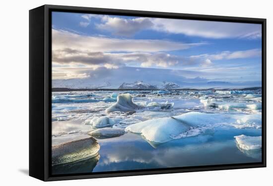 Mountains Behind Icebergs Locked in the Frozen Water of Jokulsarlon Lagoon-Neale Clark-Framed Stretched Canvas