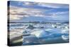 Mountains Behind Icebergs Locked in the Frozen Water of Jokulsarlon Lagoon-Neale Clark-Stretched Canvas