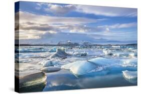 Mountains Behind Icebergs Locked in the Frozen Water of Jokulsarlon Lagoon-Neale Clark-Stretched Canvas