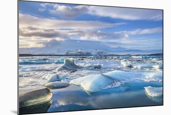 Mountains Behind Icebergs Locked in the Frozen Water of Jokulsarlon Lagoon-Neale Clark-Mounted Photographic Print