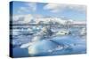 Mountains Behind the Icebergs Locked in the Frozen Water of Jokulsarlon Iceberg Lagoon-Neale Clark-Stretched Canvas