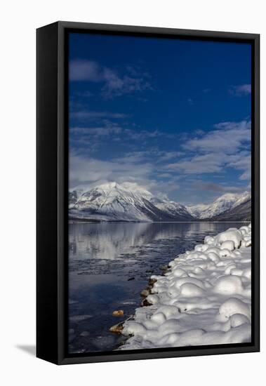 Mountains reflect in wintry Lake McDonald in Glacier National Park, Montana, USA-Chuck Haney-Framed Stretched Canvas