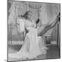 Movie Actress Carole Landis in Negligee as she Brushes Her Hair, Showing Off Gorgeous Legs-Peter Stackpole-Mounted Premium Photographic Print