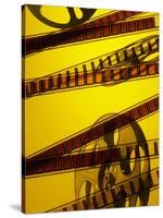 Movie Film and Reel in Yellow Light-null-Stretched Canvas