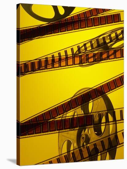 Movie Film and Reel in Yellow Light-null-Stretched Canvas