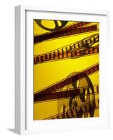 Movie Film and Reel in Yellow Light-null-Framed Photographic Print