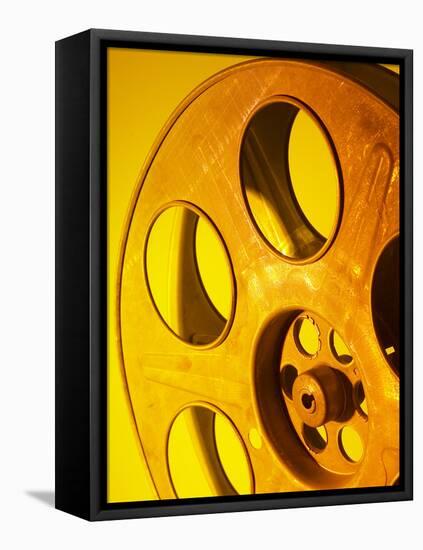 Movie Film and Reels in Yellow Light-null-Framed Stretched Canvas