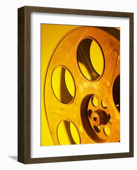 Movie Film and Reels in Yellow Light-null-Framed Photographic Print