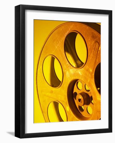 Movie Film and Reels in Yellow Light-null-Framed Photographic Print