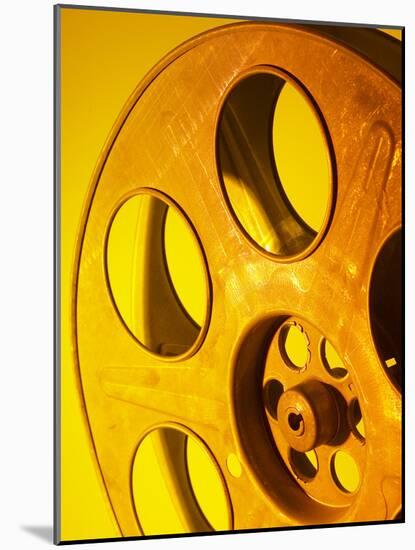 Movie Film and Reels in Yellow Light-null-Mounted Photographic Print