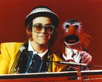 Elton John Playing Piano in Yellow Suit