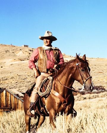John Wayne on horse in mountains