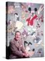 Movie Studio Head Walt Disney Sitting in Front of Backdrop Filled with Disney Creations-Alfred Eisenstaedt-Stretched Canvas