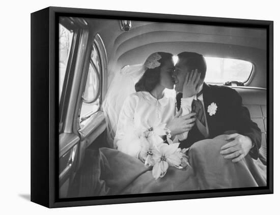 Mr. and Mrs. Thomas Beagan Jr. Kissing in Back of Car after their Wedding Ceremony-Ed Clark-Framed Stretched Canvas