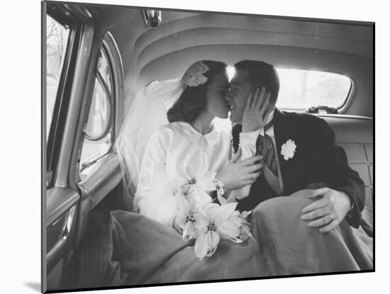 Mr. and Mrs. Thomas Beagan Jr. Kissing in Back of Car after their Wedding Ceremony-Ed Clark-Mounted Photographic Print