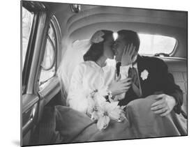 Mr. and Mrs. Thomas Beagan Jr. Kissing in Back of Car after their Wedding Ceremony-Ed Clark-Mounted Photographic Print