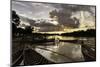 Mrauk U boat jetty at sunset showing waterlogged canoes in the foreground, Rakhine, Myanmar-Brian Graney-Mounted Photographic Print