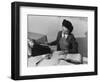 Mrs Teruko Kiyomura, bookkeeper, seated at desk, operating an adding machine while reading a ledger-Ansel Adams-Framed Photographic Print