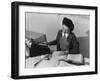 Mrs Teruko Kiyomura, bookkeeper, seated at desk, operating an adding machine while reading a ledger-Ansel Adams-Framed Photographic Print