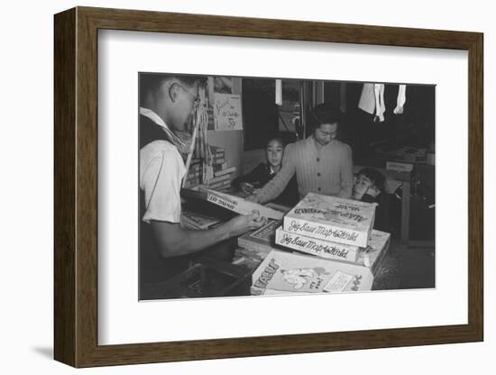 Mrs. Yaeko Nakamura shows her daughters jigsaw puzzles in a store at Manzanar, 1943-Ansel Adams-Framed Photographic Print