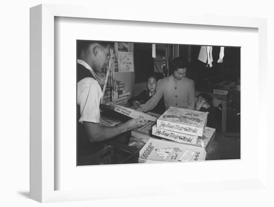 Mrs. Yaeko Nakamura shows her daughters jigsaw puzzles in a store at Manzanar, 1943-Ansel Adams-Framed Photographic Print