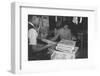 Mrs. Yaeko Nakamura shows her daughters jigsaw puzzles in a store at Manzanar, 1943-Ansel Adams-Framed Photographic Print