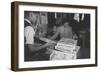 Mrs. Yaeko Nakamura shows her daughters jigsaw puzzles in a store at Manzanar, 1943-Ansel Adams-Framed Photographic Print