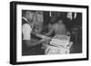 Mrs. Yaeko Nakamura shows her daughters jigsaw puzzles in a store at Manzanar, 1943-Ansel Adams-Framed Photographic Print