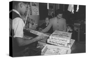 Mrs. Yaeko Nakamura shows her daughters jigsaw puzzles in a store at Manzanar, 1943-Ansel Adams-Stretched Canvas