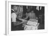 Mrs. Yaeko Nakamura shows her daughters jigsaw puzzles in a store at Manzanar, 1943-Ansel Adams-Framed Photographic Print