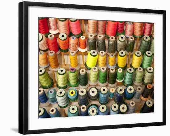 Multi-colored thread in high school sewing class-null-Framed Photographic Print