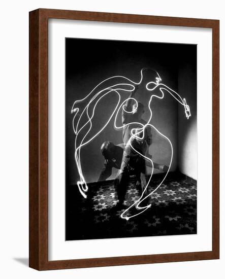 Multiple Exposure of Artist Pablo Picasso Using Flashlight to Make Light Drawing of a Figure-Gjon Mili-Framed Photographic Print