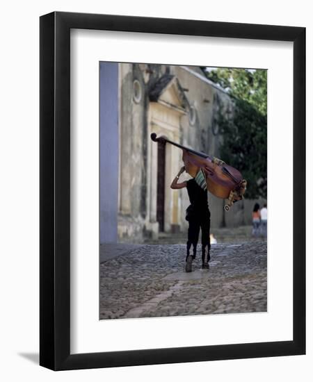 Musician Carrying Double Bass Along Cobbled Street to Plaza Mayor, Trinidad, Cuba-Lee Frost-Framed Photographic Print