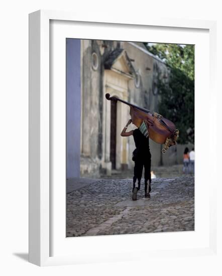 Musician Carrying Double Bass Along Cobbled Street to Plaza Mayor, Trinidad, Cuba-Lee Frost-Framed Photographic Print