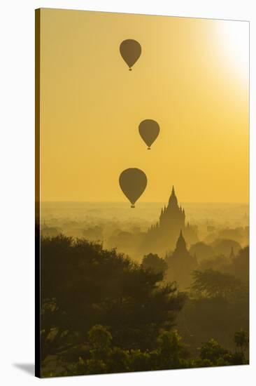 Myanmar. Bagan. Hot Air Balloons Rising over the Temples of Bagan-Inger Hogstrom-Stretched Canvas