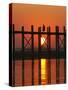 Myanmar (Burma), Amarapura, Taungthaman Lake, U Bein's Bridge, a Monk Walking Home at Sunset-Katie Garrod-Stretched Canvas