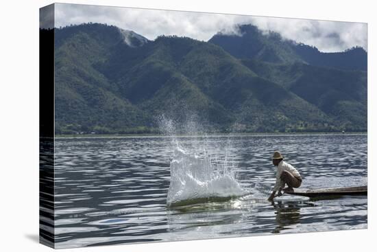 Myanmar, Inle Lake. Man Slaps His Paddle on the Surface of the Lake to Stun the Fish-Brenda Tharp-Stretched Canvas