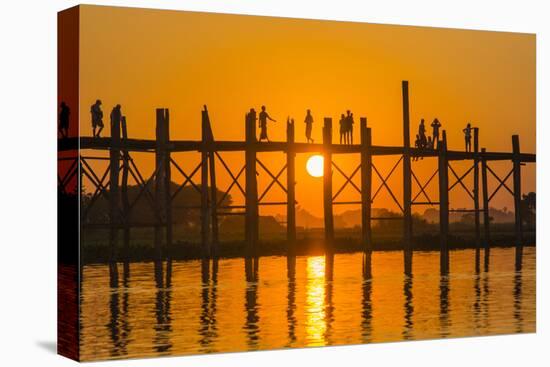 Myanmar. Mandalay. Amarapura. Tourists on the U Bein Bridge at Sunset-Inger Hogstrom-Stretched Canvas