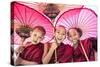 Myanmar, Mandalay Division, Bagan. Portrait of Three Novice Monks under Red Umbrellas (Mr)-Matteo Colombo-Stretched Canvas