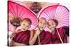 Myanmar, Mandalay Division, Bagan. Portrait of Three Novice Monks under Red Umbrellas (Mr)-Matteo Colombo-Stretched Canvas