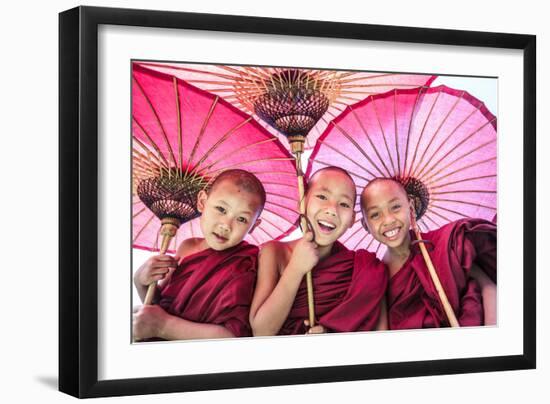 Myanmar, Mandalay Division, Bagan. Portrait of Three Novice Monks under Red Umbrellas (Mr)-Matteo Colombo-Framed Photographic Print