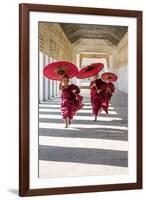 Myanmar, Mandalay Division, Bagan. Three Novice Monks Running with Red Umbrellas in a Walkway (Mr)-Matteo Colombo-Framed Photographic Print