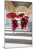 Myanmar, Mandalay Division, Bagan. Three Novice Monks Running with Red Umbrellas in a Walkway (Mr)-Matteo Colombo-Mounted Photographic Print