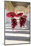 Myanmar, Mandalay Division, Bagan. Three Novice Monks Running with Red Umbrellas in a Walkway (Mr)-Matteo Colombo-Mounted Premium Photographic Print