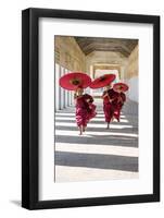 Myanmar, Mandalay Division, Bagan. Three Novice Monks Running with Red Umbrellas in a Walkway (Mr)-Matteo Colombo-Framed Photographic Print